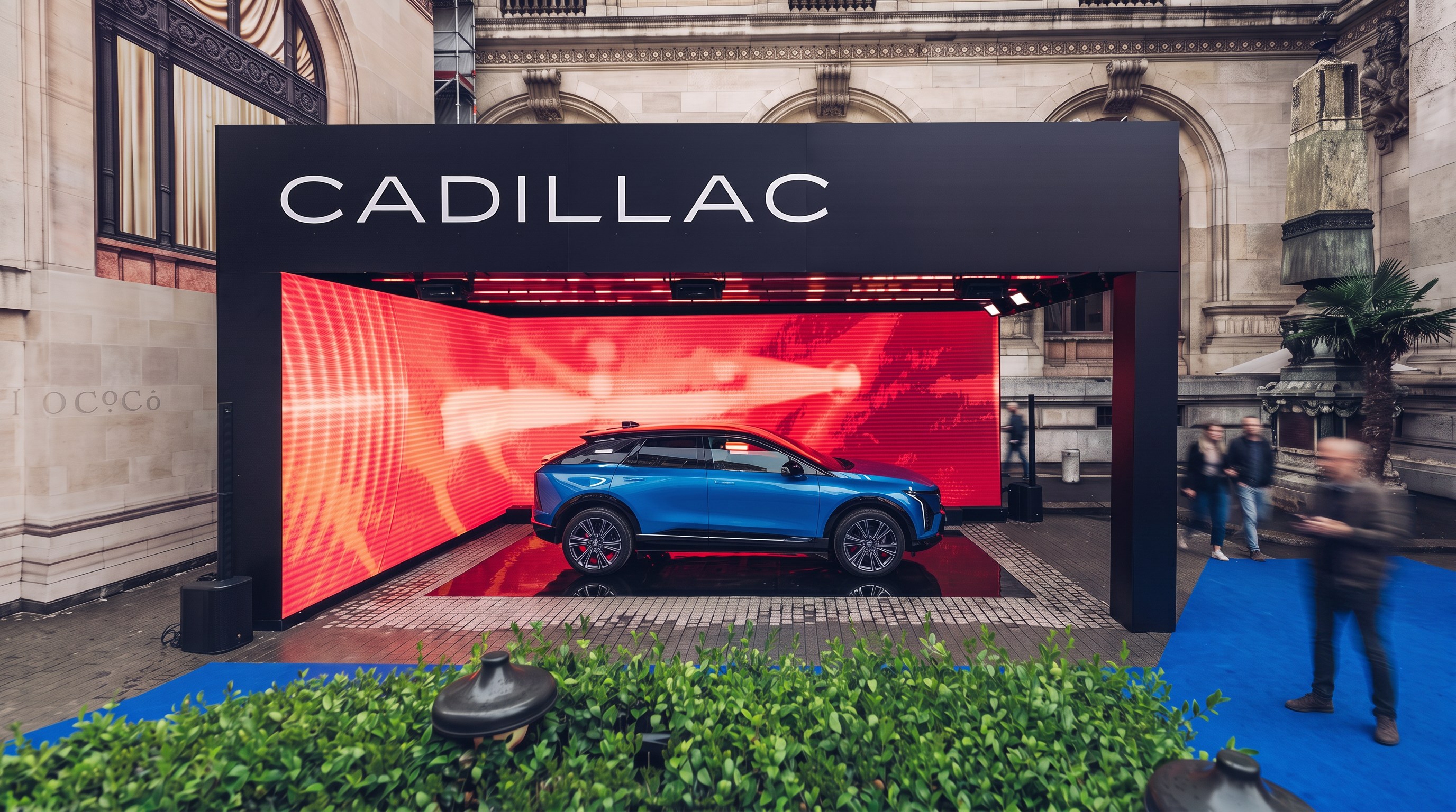 Street activation: a Cadillac on a red LED stage against a stone facade