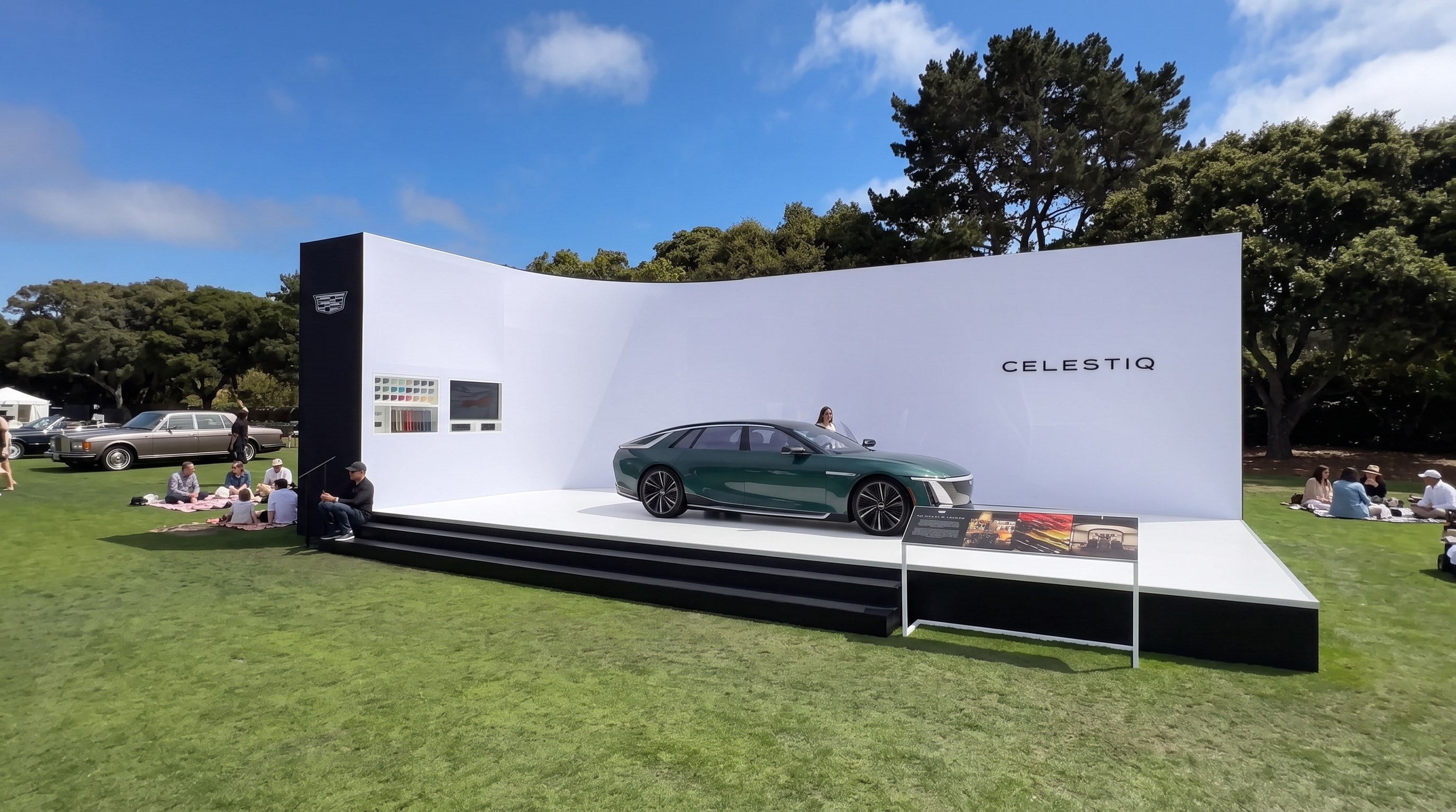 Celestiq display pavilion on the lawn at The Quail, white wall and black plinth