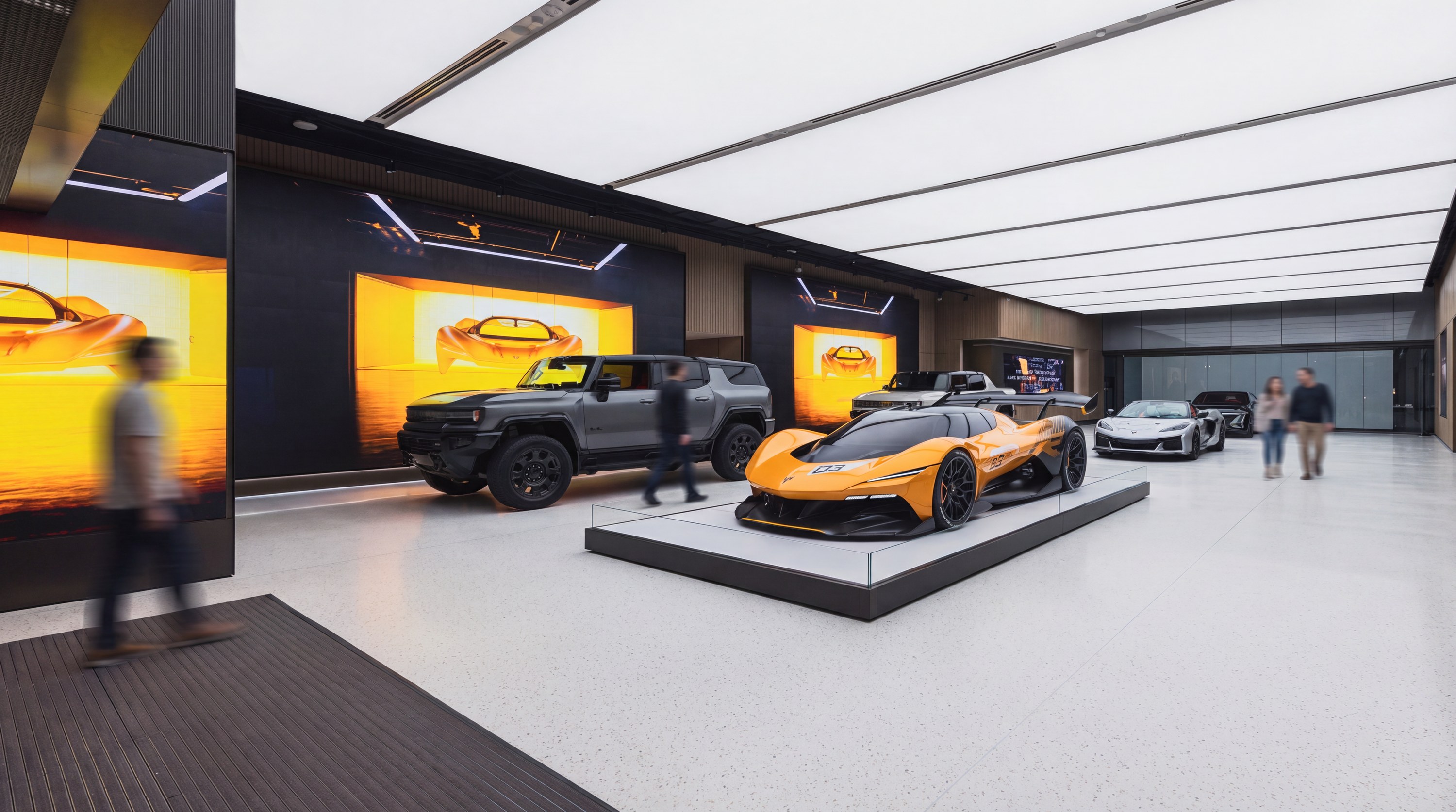 Showroom gallery with vehicles against amber light boxes